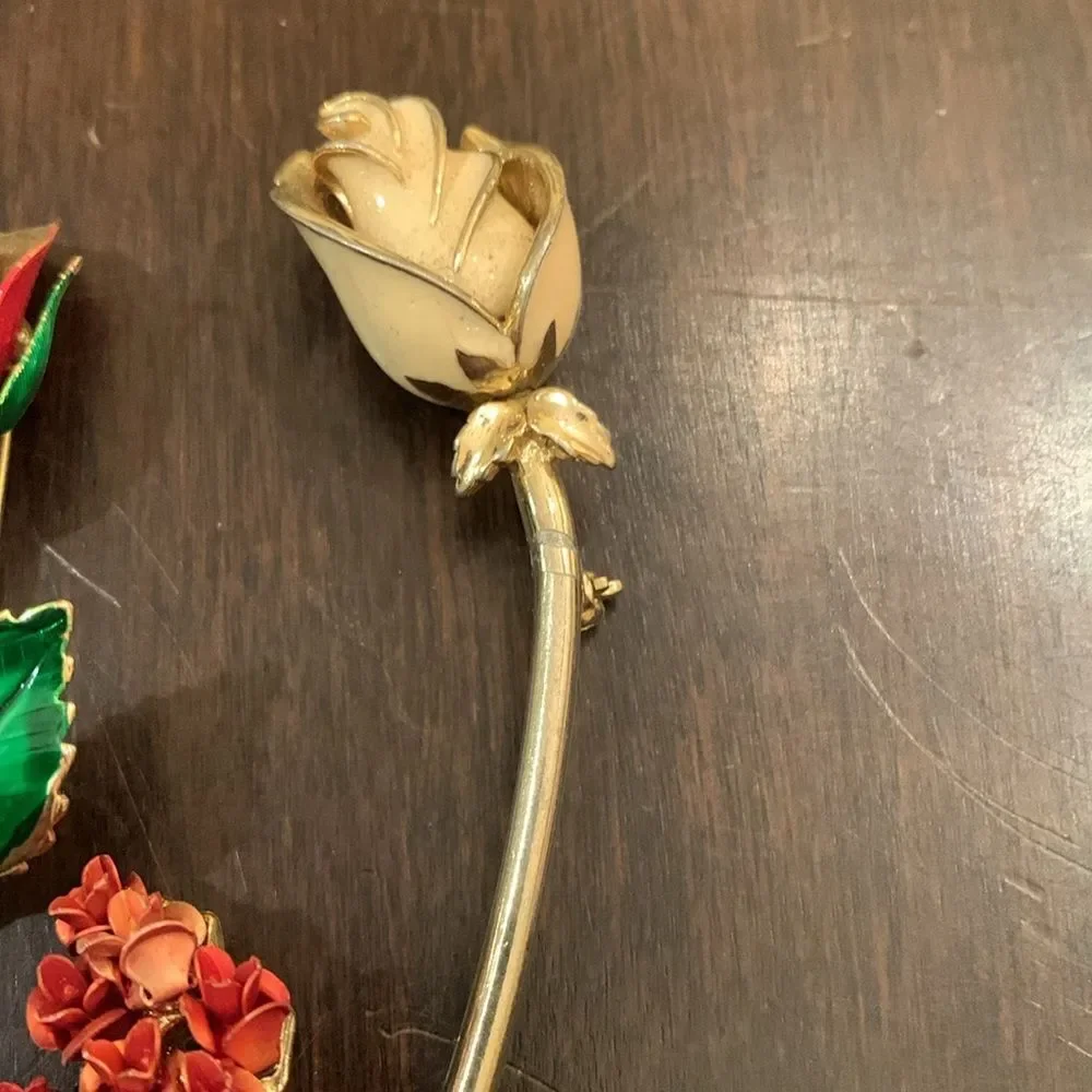 Three vintage rose brooches